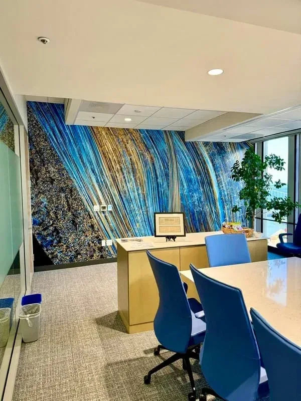 A blue patterned mural wall inside an empty contemporary office