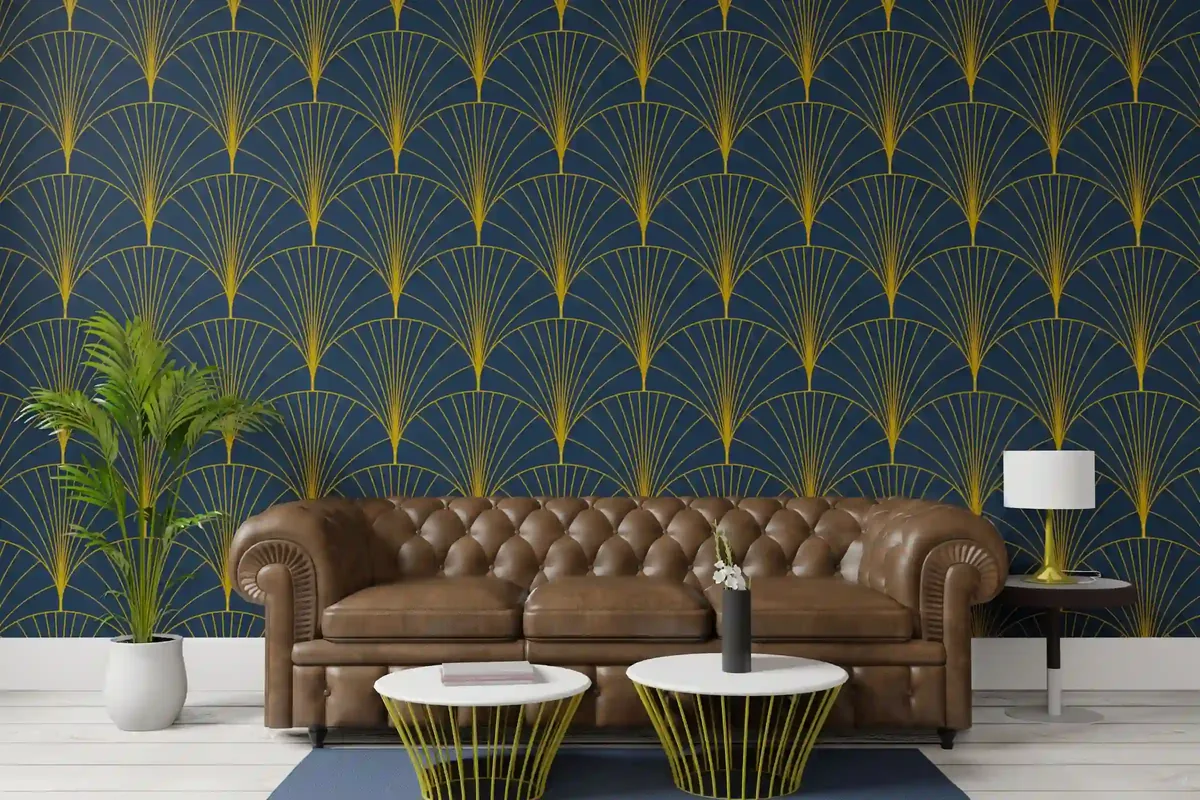 Navy wallpaper with a repeated gold fan pattern behind a sofa